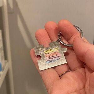 Silver Puzzle Piece Keychain with Multicolor Script